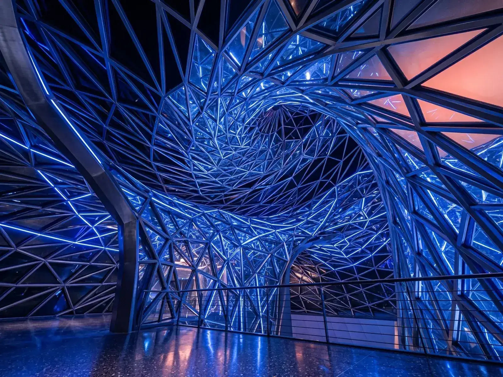 Abstract curved glass and steel architectural lattice structure with dramatic lighting